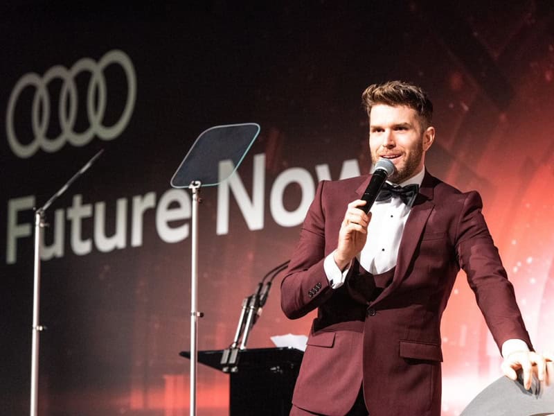Joel Dommett presenting at Audi graduation